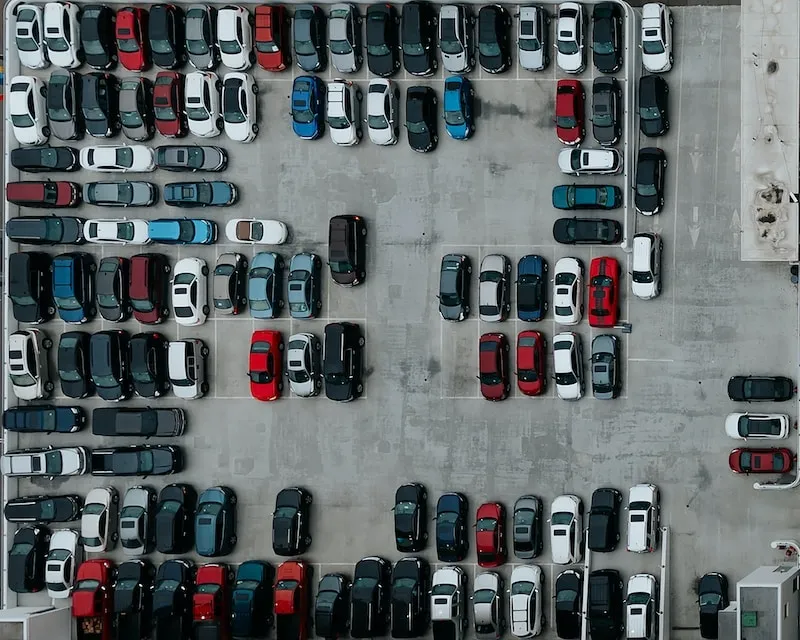 Imagem da vista aérea de um estacionamento com muitos carros.